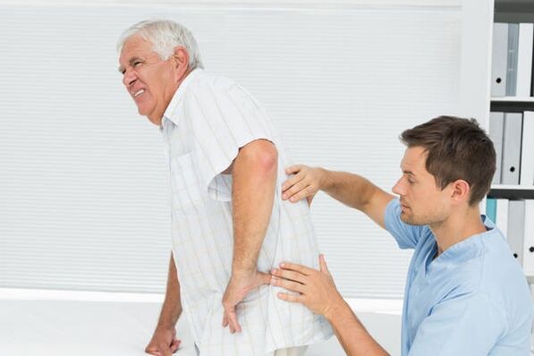 Elderly patient with low back pain seen by a doctor